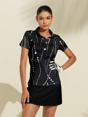 Woman wearing a black short-sleeve golf polo with white abstract print and a black golf skirt.