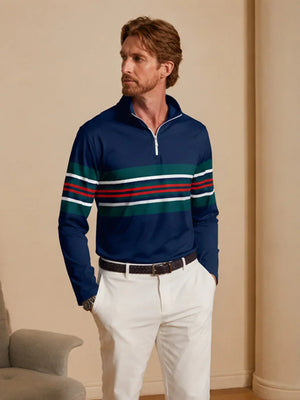 Man wearing a navy blue quarter-zip golf pullover with multi-color stripes and white pants.