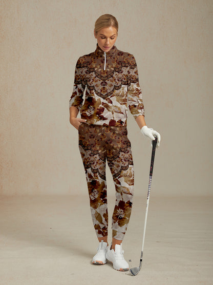 Woman wearing a patterned floral golf tracksuit with a quarter-zip top and matching pants.