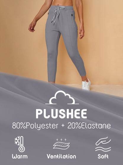 Women's grey plushee performance golf pants featuring a drawstring waist and zip pockets.