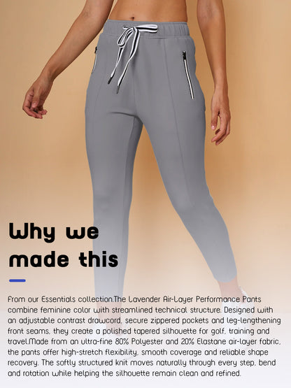 Women's grey performance golf pants with adjustable drawstring and zippered pockets.