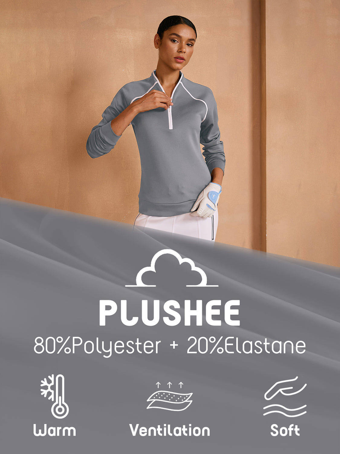 Woman wearing a grey long-sleeve performance golf pullover and white skirt.