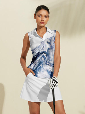 Woman wearing a blue and white marble print sleeveless golf polo and white golf skirt.