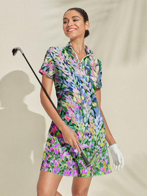 Smiling woman in a colorful floral print women's golf dress holding a golf club.