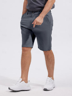 Man wearing grey performance golf shorts and white sneakers