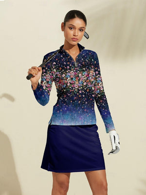 Woman wearing a floral print long sleeve golf top and navy blue golf skirt
