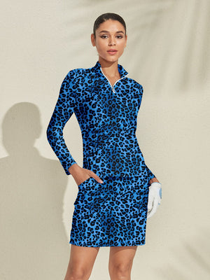 Woman wearing a blue leopard print long sleeve golf dress with a quarter zip.