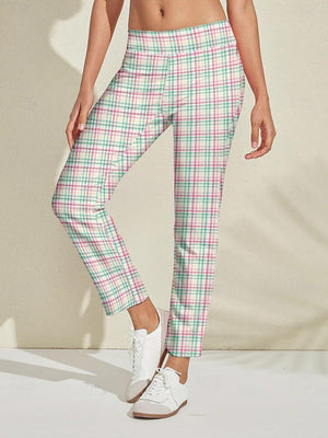 Woman wearing colorful plaid women's golf trousers and white athletic shoes.