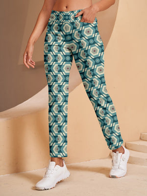 Woman wearing teal and beige geometric patterned golf pants and white sneakers.