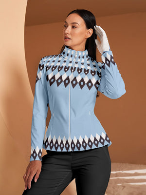 Woman wearing a light blue zip-up golf jacket with navy and white diamond patterns.